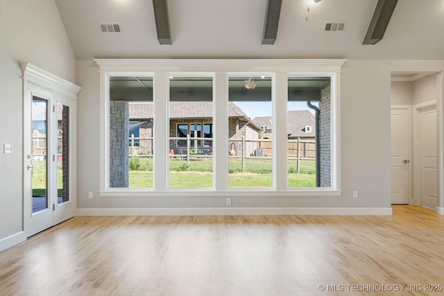 unfurnished room featuring vaulted ceiling with beams and light hardwood / wood-style floors