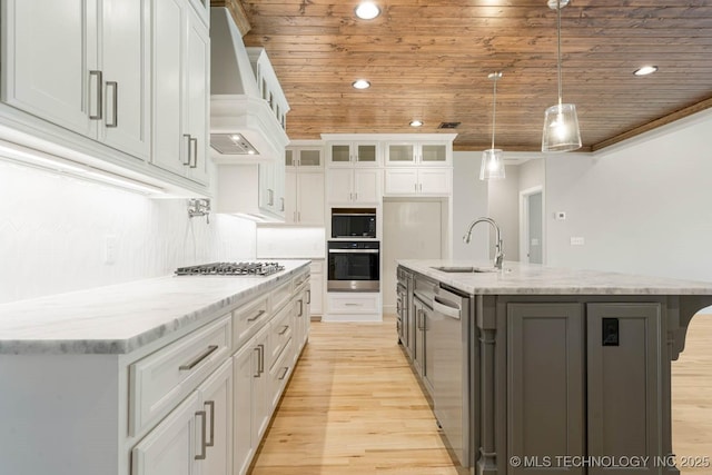 kitchen featuring stainless steel appliances, white cabinetry, wooden ceiling, and sink