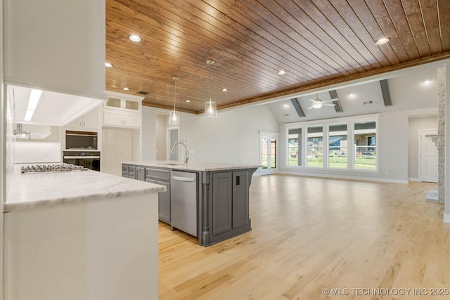 kitchen featuring white cabinets, lofted ceiling with beams, wood ceiling, and appliances with stainless steel finishes