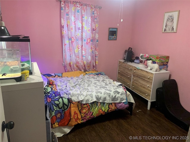 bedroom with dark hardwood / wood-style floors