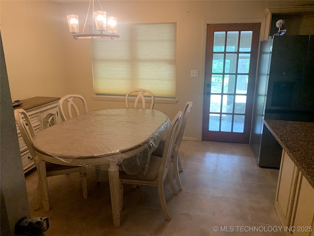 dining area with an inviting chandelier