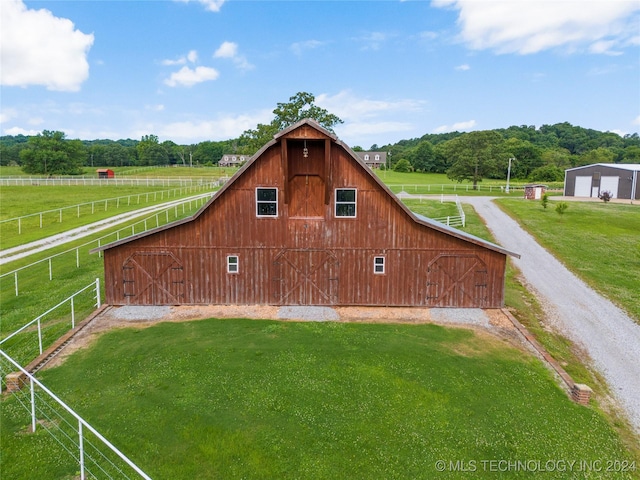 exterior space with a rural view and an outbuilding