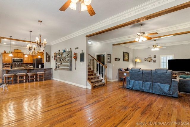 living room featuring light wood-type flooring, ceiling fan with notable chandelier, and ornamental molding