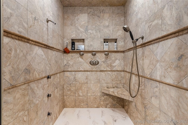 bathroom with a tile shower