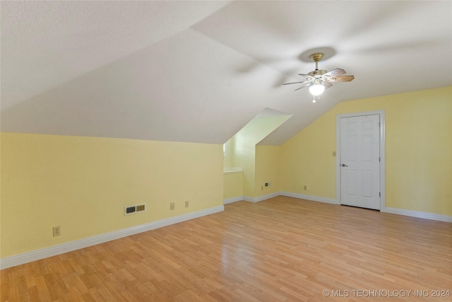 additional living space featuring ceiling fan, light hardwood / wood-style floors, and vaulted ceiling