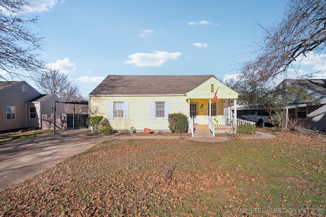 bungalow-style house featuring a porch and a front lawn