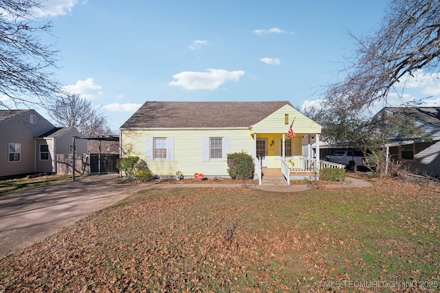 4519 E 5th Pl, Tulsa, OK 74112 - view of front of property with a porch, a front lawn, and concrete driveway