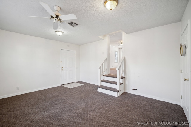 interior space with ceiling fan and a textured ceiling