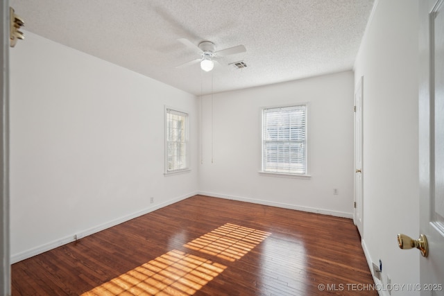 empty room featuring hardwood / wood-style floors, ceiling fan, and a textured ceiling