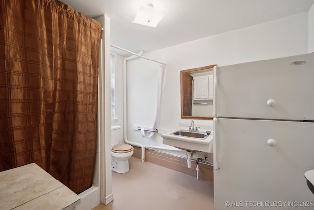 bathroom with a shower, toilet, and sink