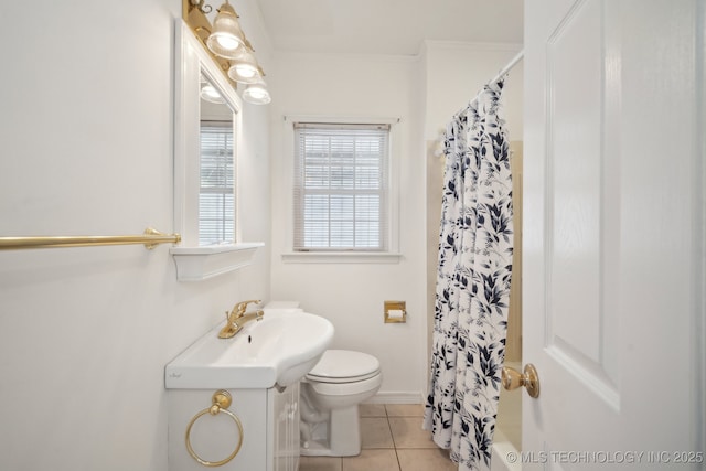 bathroom with tile patterned floors, crown molding, vanity, and toilet