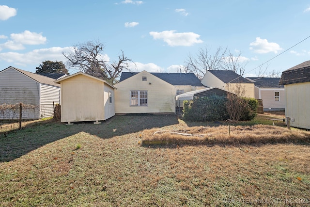 back of property featuring a yard and a storage shed