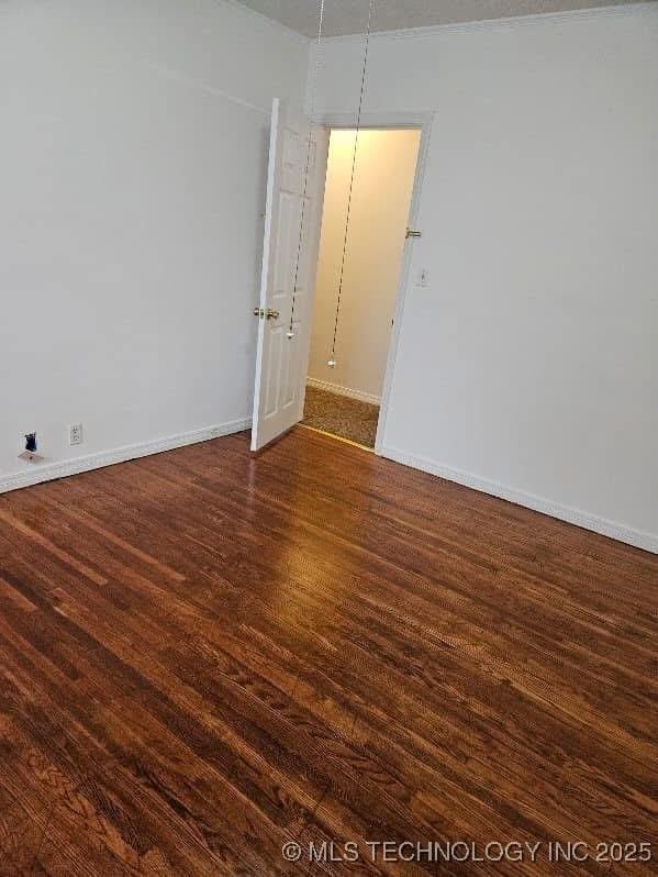 4519 E 5th Pl, Tulsa, OK 74112 - spare room with dark wood finished floors and baseboards