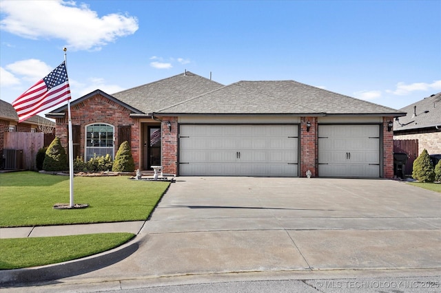 ranch-style home with central air condition unit, a front lawn, and a garage