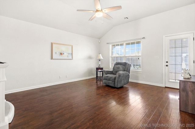 living area featuring vaulted ceiling, ceiling fan, and dark wood-type flooring