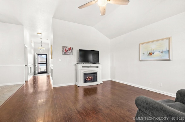 living room featuring wood-type flooring, vaulted ceiling, and ceiling fan