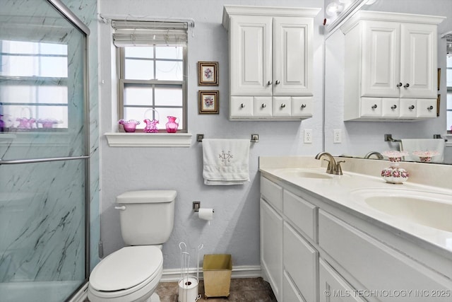 bathroom with a wealth of natural light, vanity, and an enclosed shower