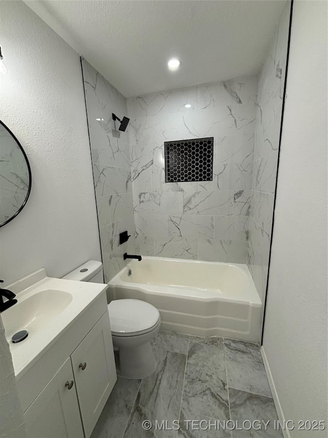 full bathroom with vanity, a textured ceiling, tiled shower / bath combo, and toilet