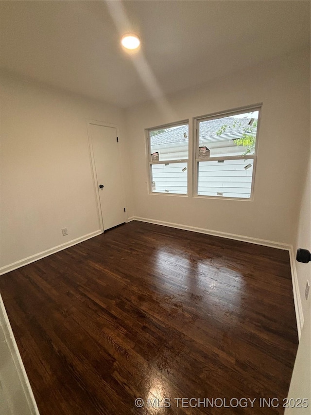 empty room featuring dark hardwood / wood-style floors