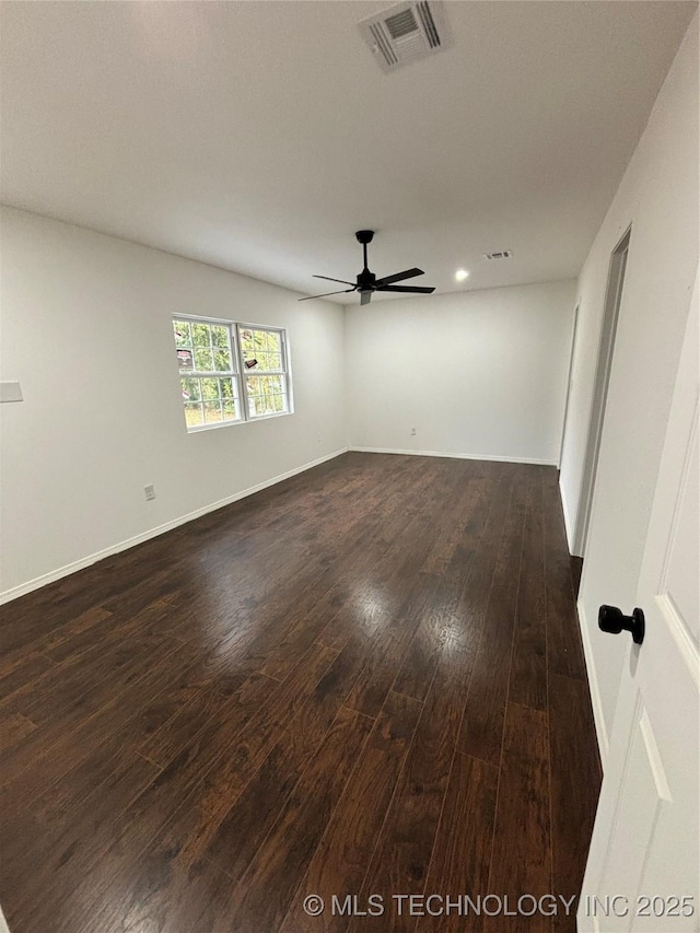 unfurnished room featuring ceiling fan and dark wood-type flooring