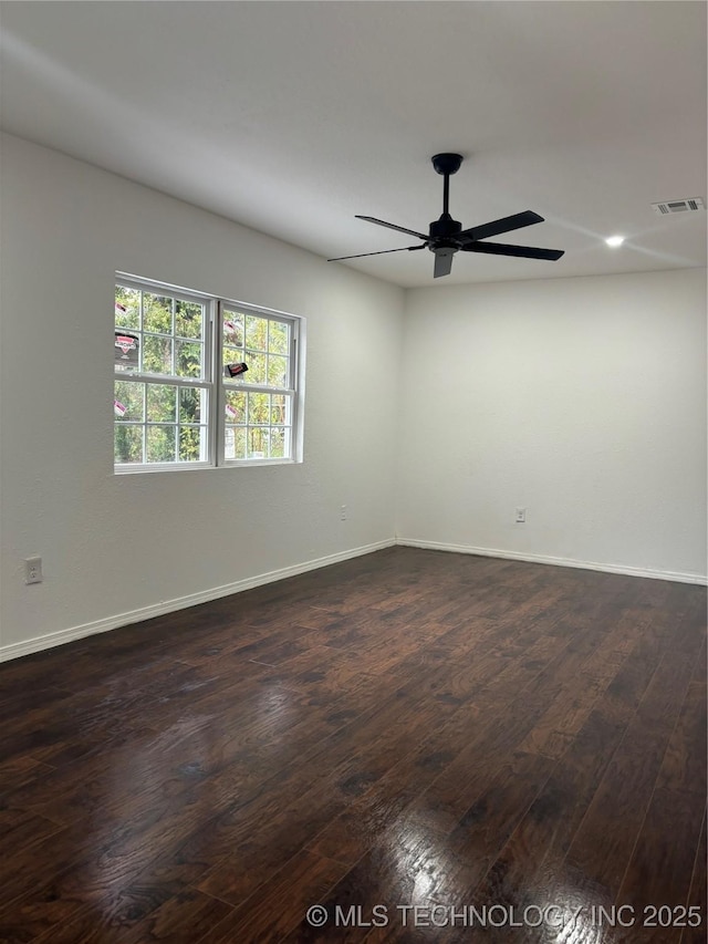 unfurnished room featuring ceiling fan and dark hardwood / wood-style flooring