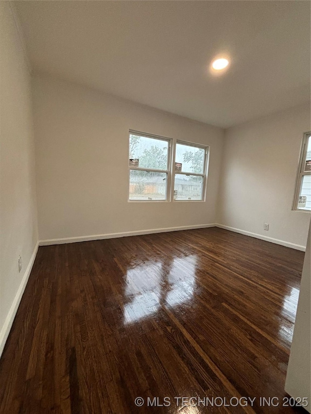 spare room with dark hardwood / wood-style flooring