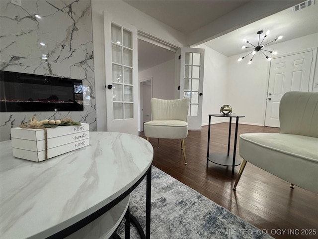 interior space featuring beamed ceiling, a chandelier, and hardwood / wood-style floors