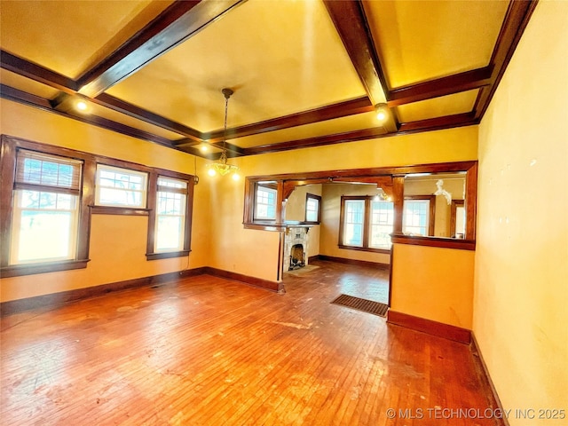 unfurnished living room featuring beamed ceiling, coffered ceiling, and hardwood / wood-style flooring