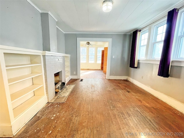 unfurnished living room with hardwood / wood-style flooring, ceiling fan, and a fireplace