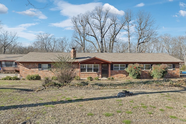 ranch-style home with a front lawn