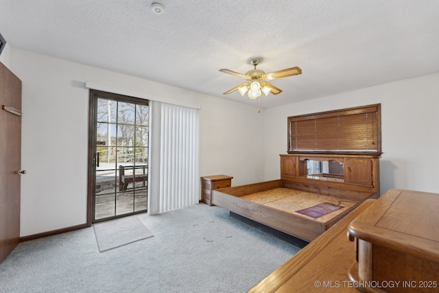 carpeted living room with ceiling fan and a textured ceiling