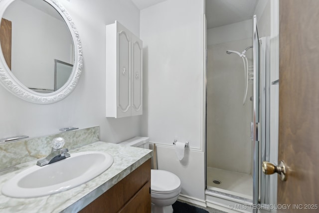 bathroom featuring vanity, toilet, and a shower with door