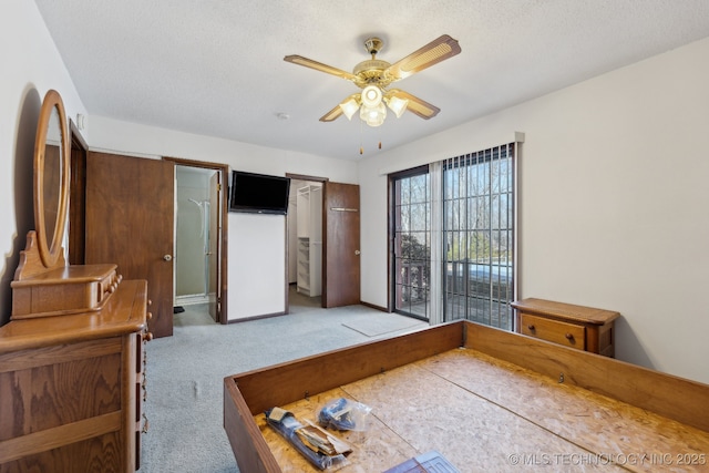 carpeted bedroom featuring a textured ceiling and ceiling fan