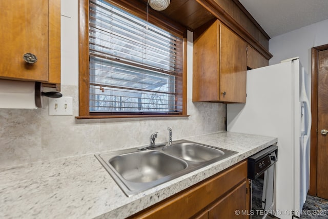 kitchen with black dishwasher, backsplash, and sink