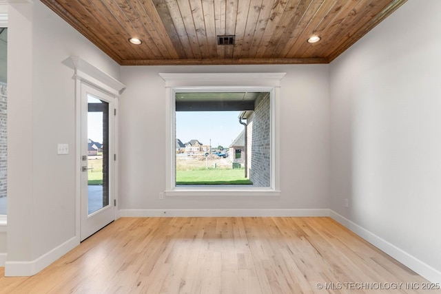 spare room with light hardwood / wood-style flooring, ornamental molding, and wood ceiling