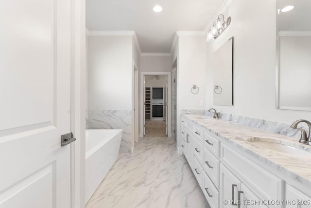 bathroom featuring a bathing tub, crown molding, vanity, and tile walls