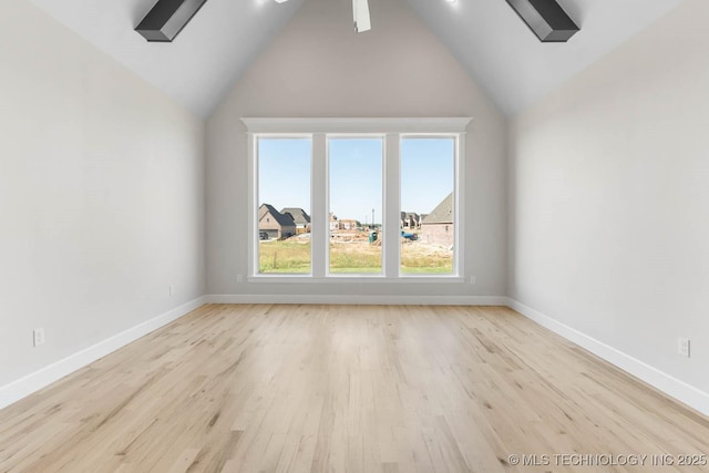 bonus room with light wood-type flooring and lofted ceiling