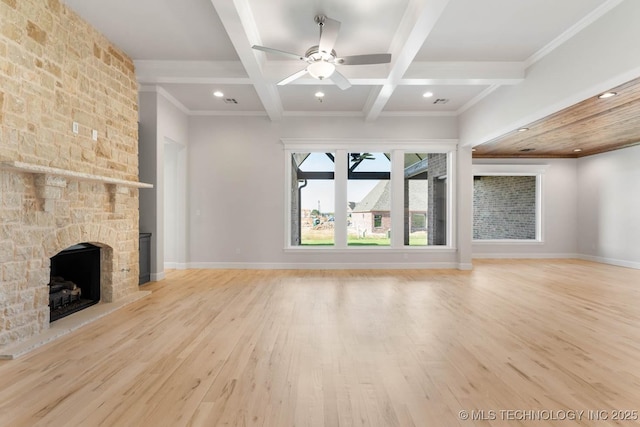 unfurnished living room featuring coffered ceiling, light hardwood / wood-style flooring, ceiling fan, a fireplace, and beamed ceiling