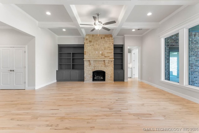 unfurnished living room featuring built in features, beamed ceiling, light hardwood / wood-style floors, and coffered ceiling