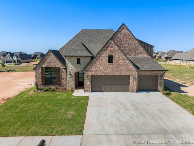 view of front of house featuring a garage and a front lawn