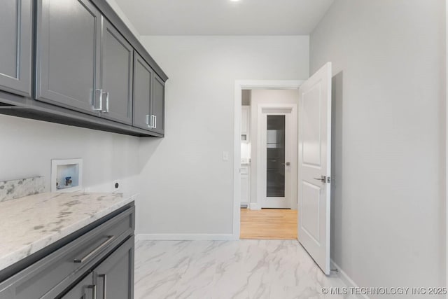 laundry room with electric dryer hookup, cabinets, and washer hookup