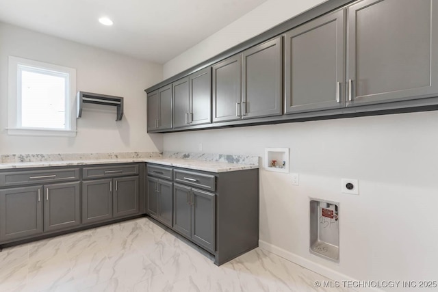 washroom with cabinets, washer hookup, and electric dryer hookup