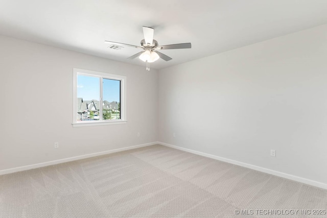 carpeted spare room with ceiling fan