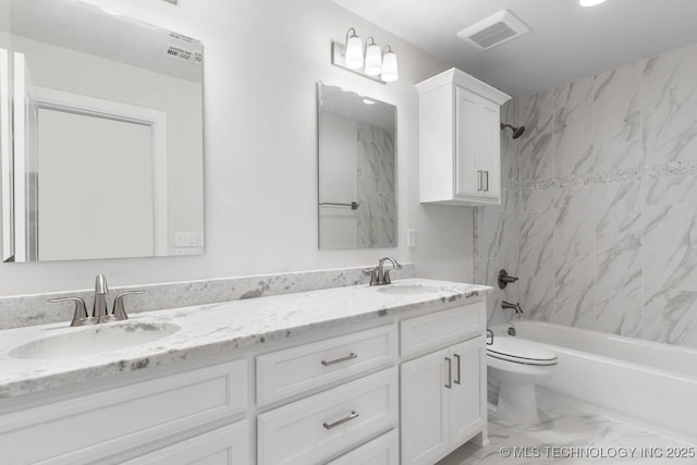 full bathroom with vanity, toilet, and tiled shower / bath