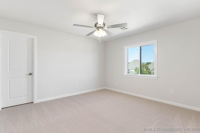 carpeted spare room with ceiling fan