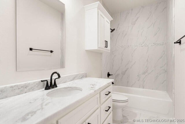 full bathroom featuring toilet, vanity, and tiled shower / bath