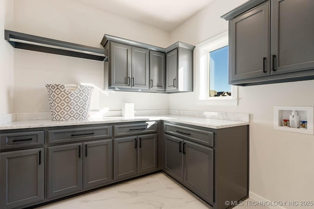 laundry room featuring hookup for a washing machine and cabinets