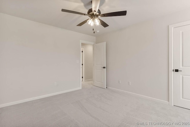 spare room featuring light carpet and ceiling fan