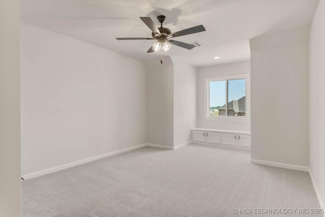 unfurnished room featuring ceiling fan and light colored carpet