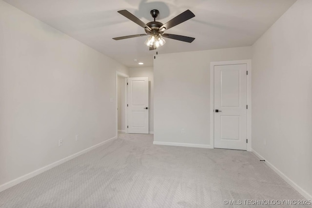 carpeted empty room featuring ceiling fan